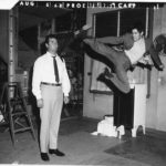 Bruce Lee practices a flying kick on James Garner on the set of Marlowe, 1968