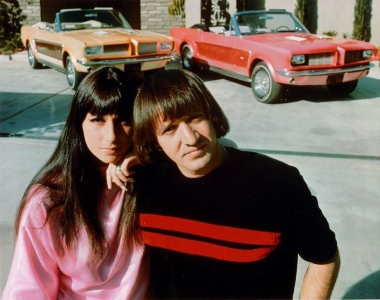Sonny & Cher at home with their custom Ford Mustangs, 1966