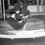 Elizabeth Taylor and her son Michael Wilding Jr. getting competitive during a rough round of bumper cars, circa 1961.