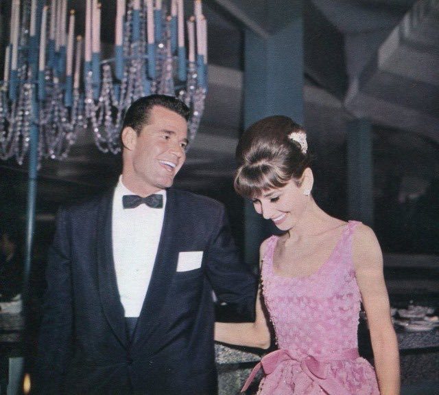 1961 James Garner & Audry Hepburn share a laugh at a dinner
