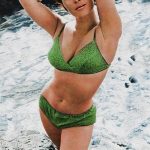 Michele Carey in a green bikini beside a river