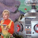 Marta Kristen as Judy Robinson posing with the Robot in a promo shot for Lost in Space, 1966.