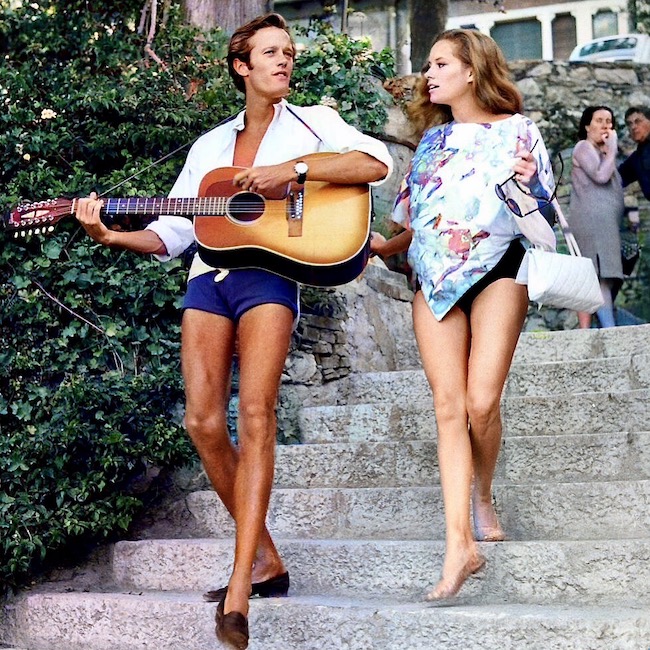 Luciana Paluzzi enjoys a musical moment as Peter Fonda strums a tune. Taormina, Italy. (1965) 