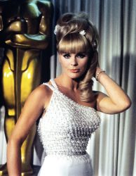 Elke Sommer attending the Oscar ceremony that was held on April 18th, 1966. She is wearing a gown that Edith Head designed for her in the film The Oscar.